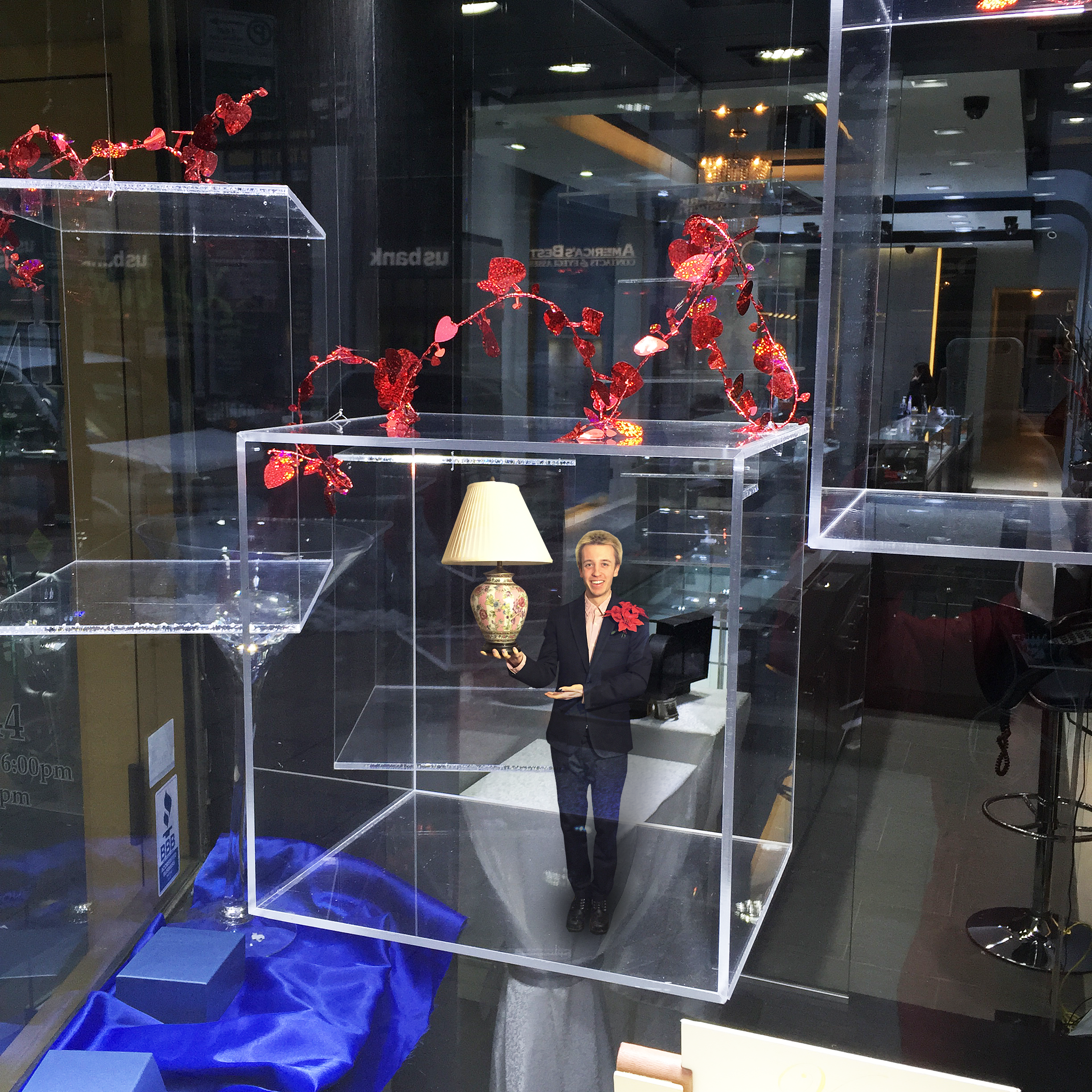 Butler holding a lamp in an empty floating jelwelry display box